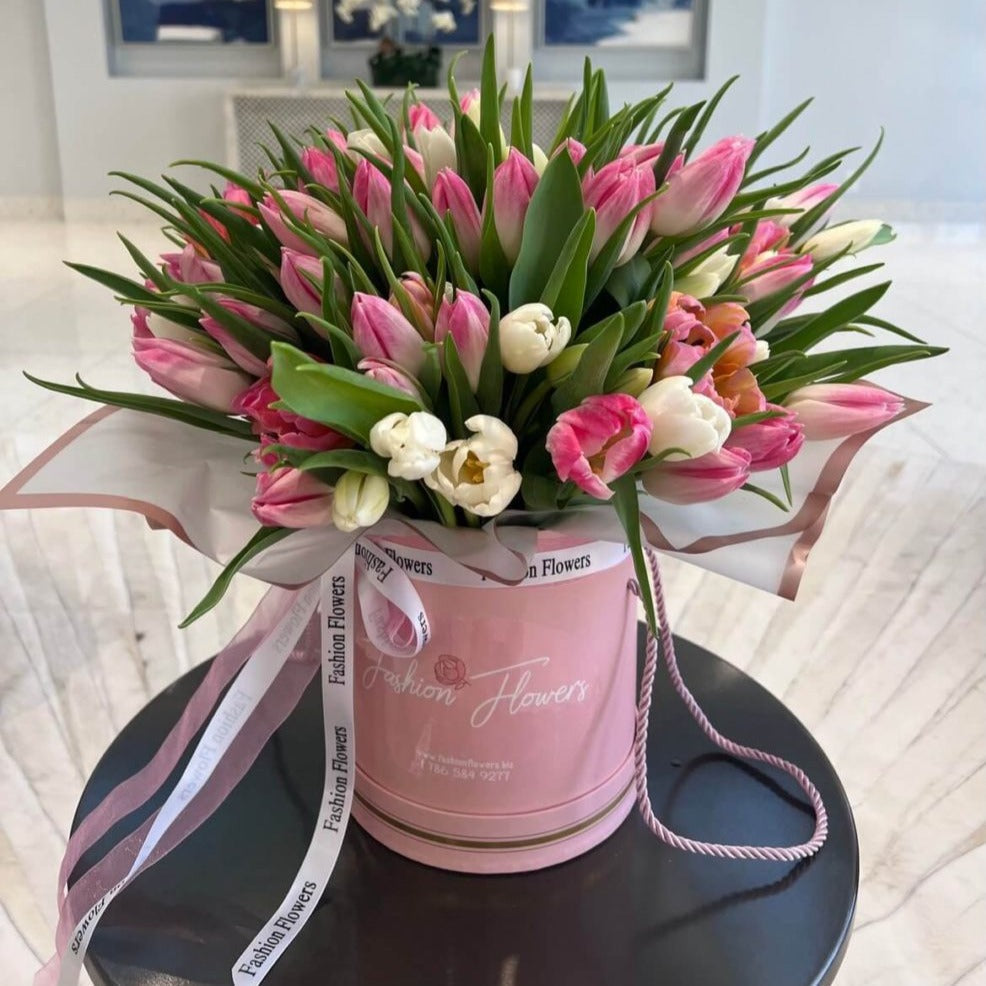 Large luxury tulip arrangement in soft pink and white in a designer hatbox â flower delivery Miami villa interior