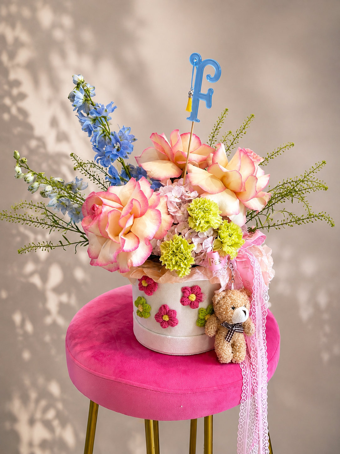 Sweet Bloom: fresh seasonal flowers, ribbons, teddy bear charm in a flower box arrangement