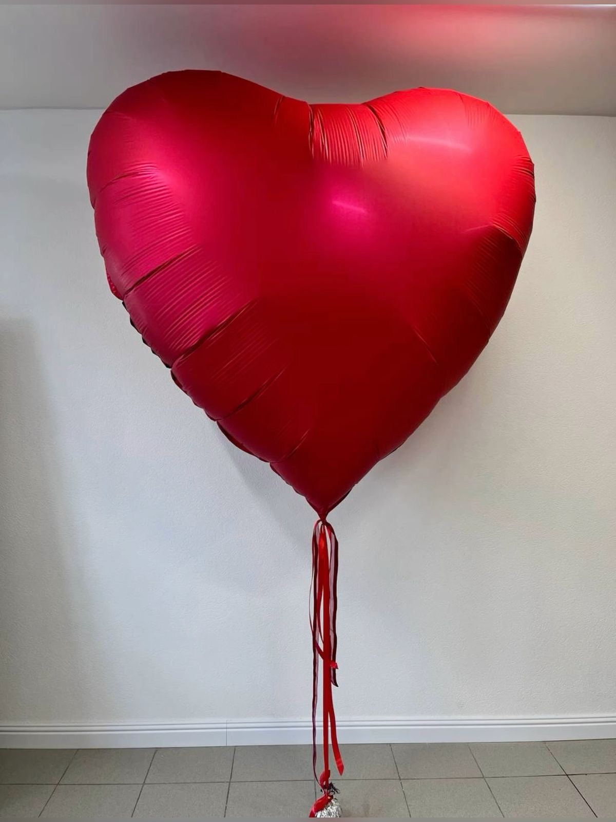 Red Heart: red heart-shaped foil balloon, ribbon tails in a heart foil balloon