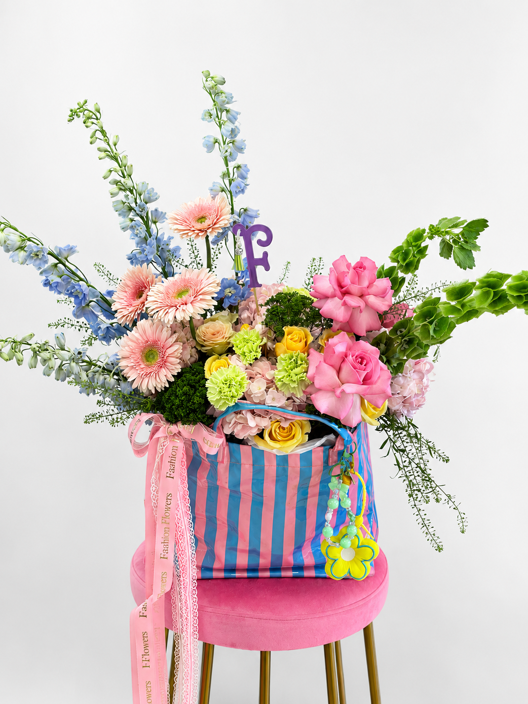 Beach Bloom: fresh seasonal flowers, decorative ribbons, keychain charms in a flower bag arrangement