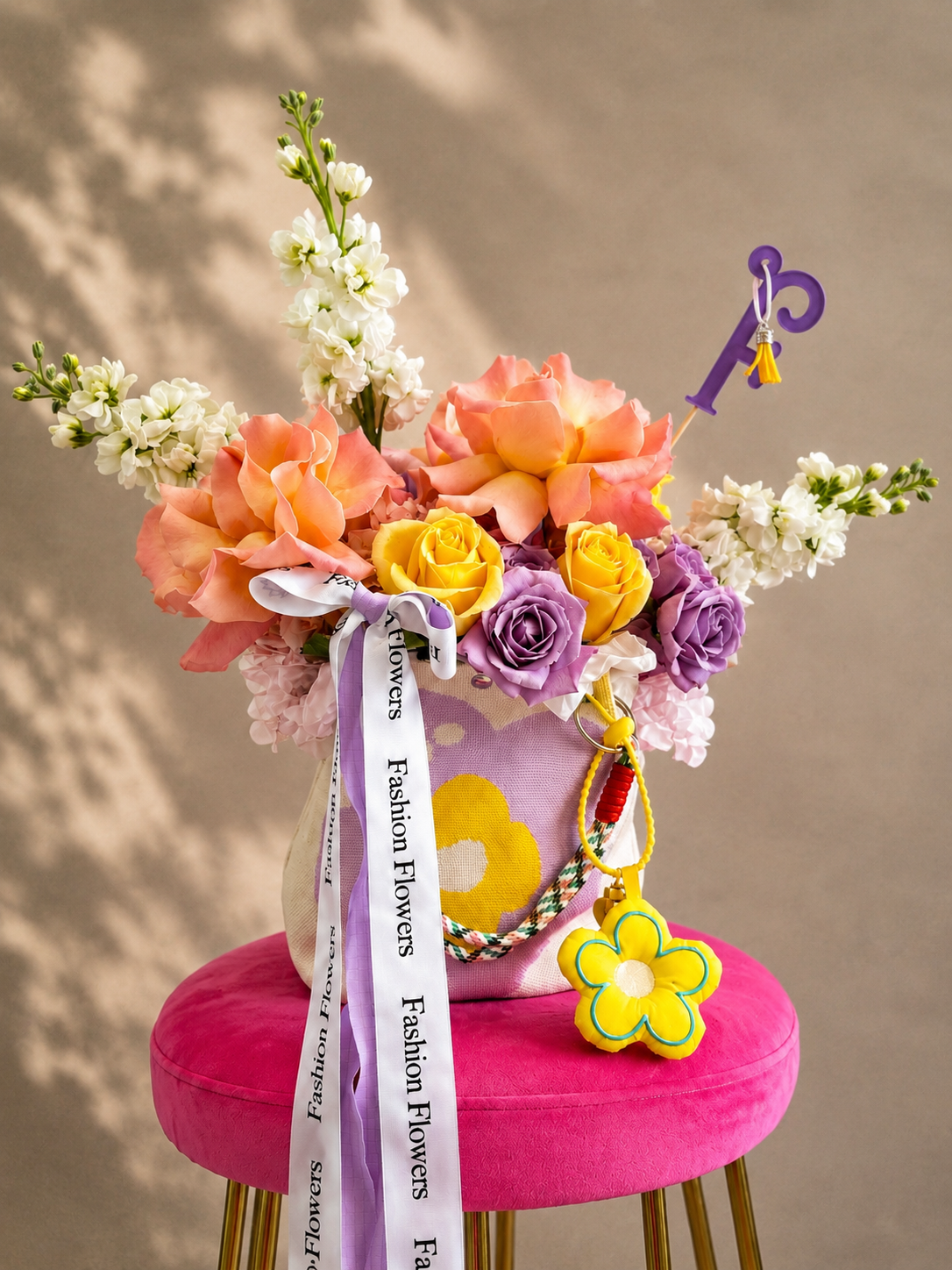 Joy: fresh seasonal flowers, ribbons, decorative accessories in a flower bag arrangement