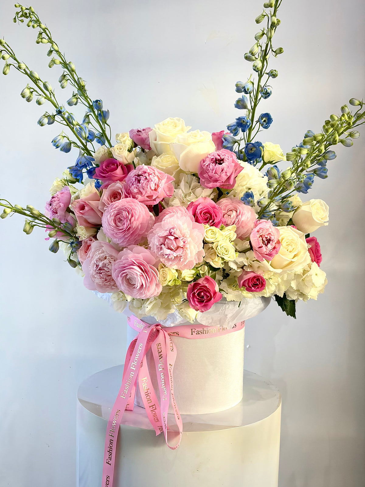 Blush & Sky Garden: roses, ranunculus, peonies, spray roses, hydrangeas, delphinium in a flower box arrangement