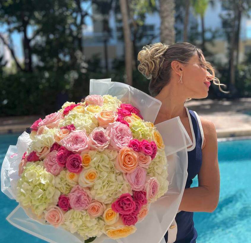 Hand-tied bouquet of pastel pink, red and peach roses — luxury flower delivery Miami, perfect for romantic surprises