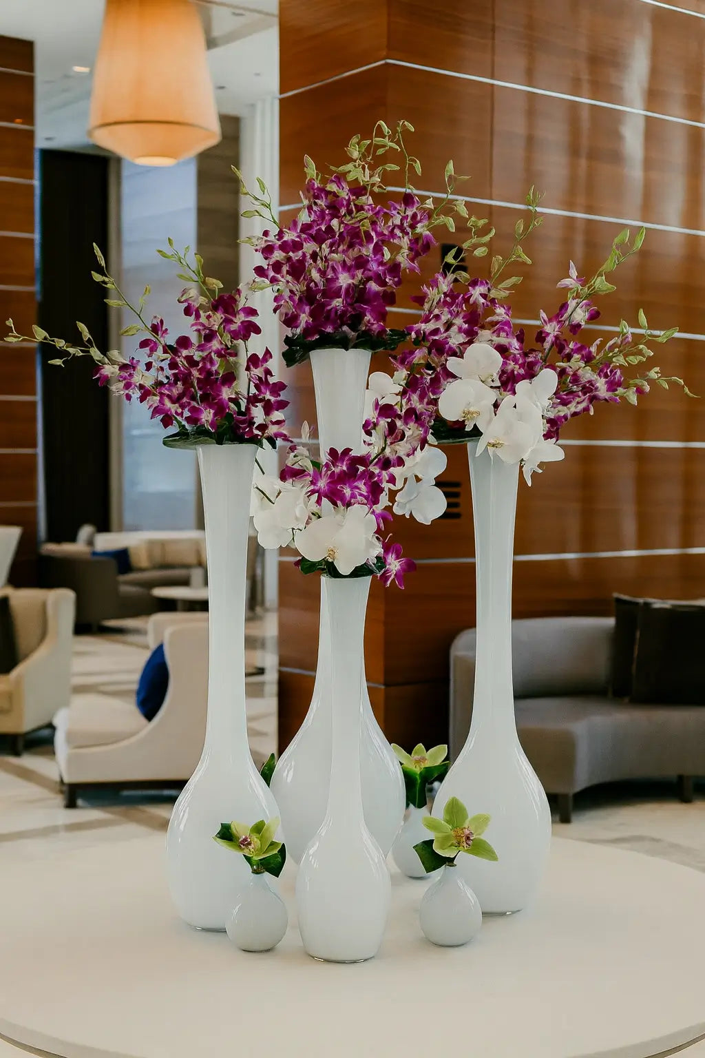 Luxury floral arrangement at Château Beach Residences with elegant orchids and modern vases in the lobby