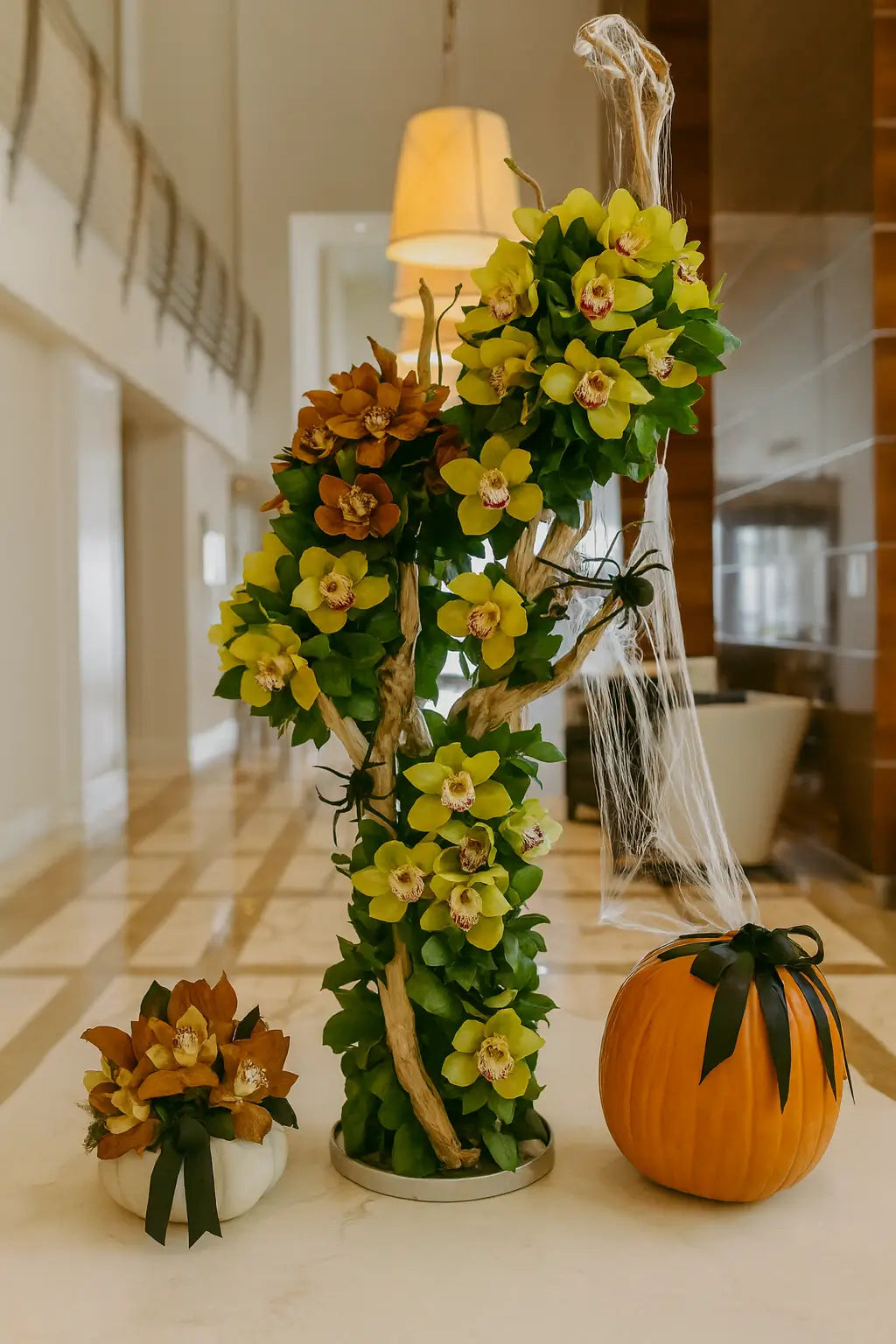 Luxury floral arrangement with orchids and pumpkins at Château Beach Residences Miami, elegant lobby decor