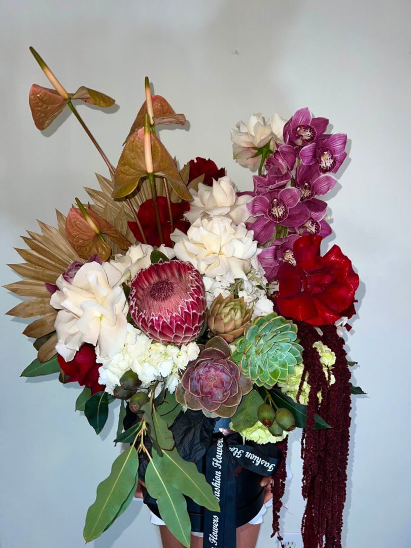 Exotic flower arrangement in rich tropical tones â hand-tied luxury bouquet for elegant interior styling.
