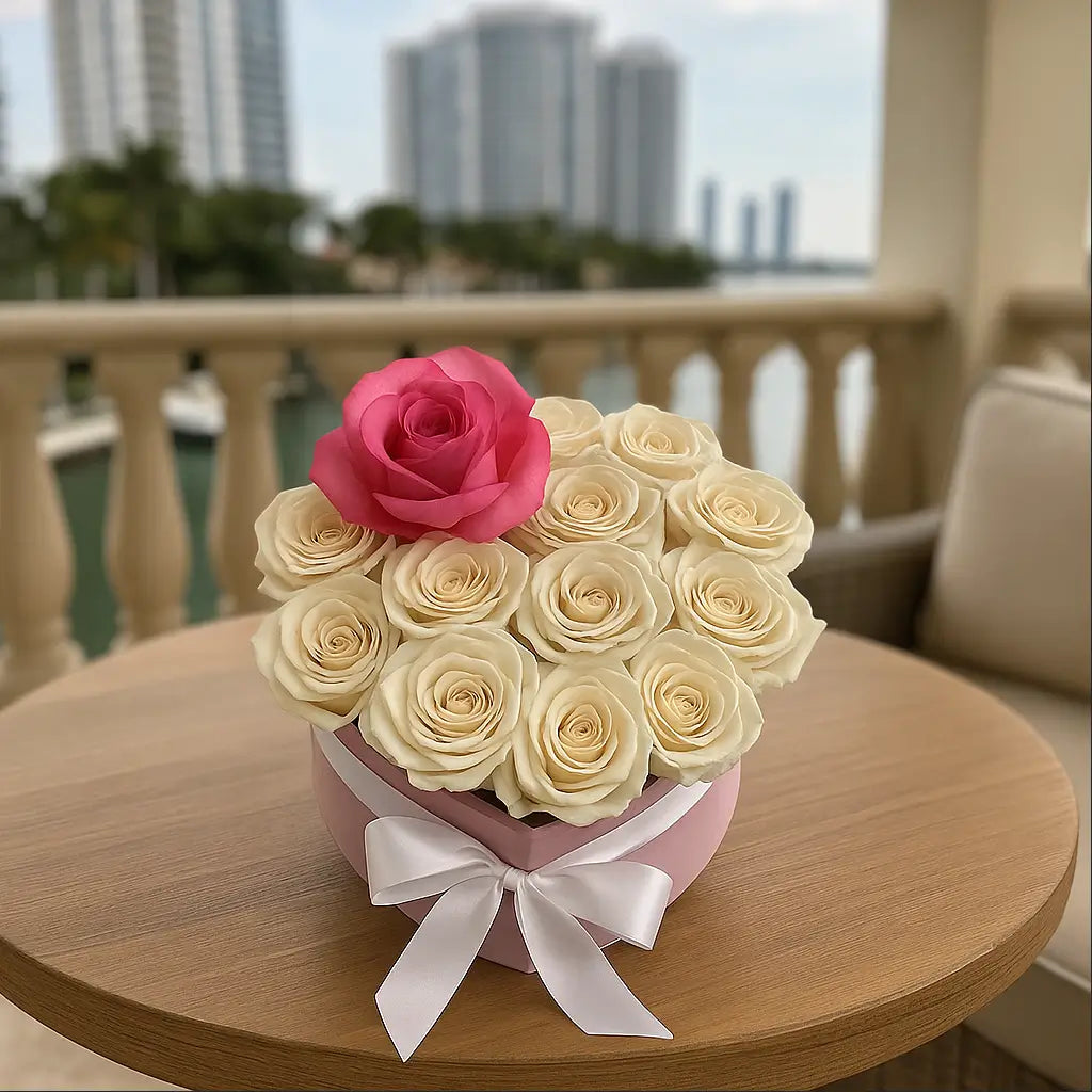 Heart-shaped box with white roses and pink accent rose on a luxury balcony â flower delivery Miami