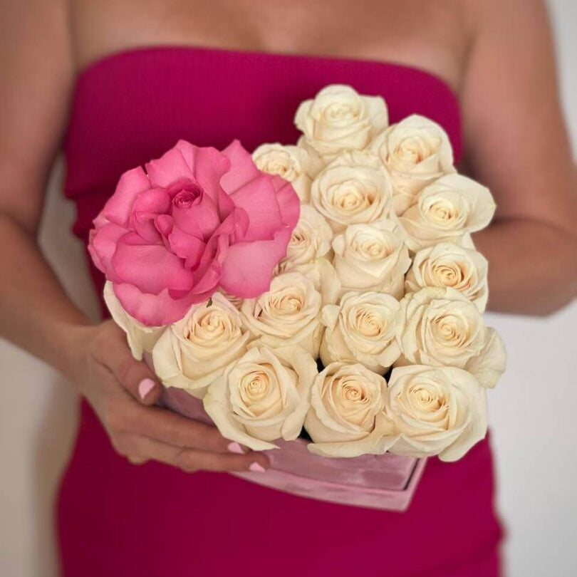 Happy woman in white dress with heart-shaped box of white and pink roses â flower delivery Miami