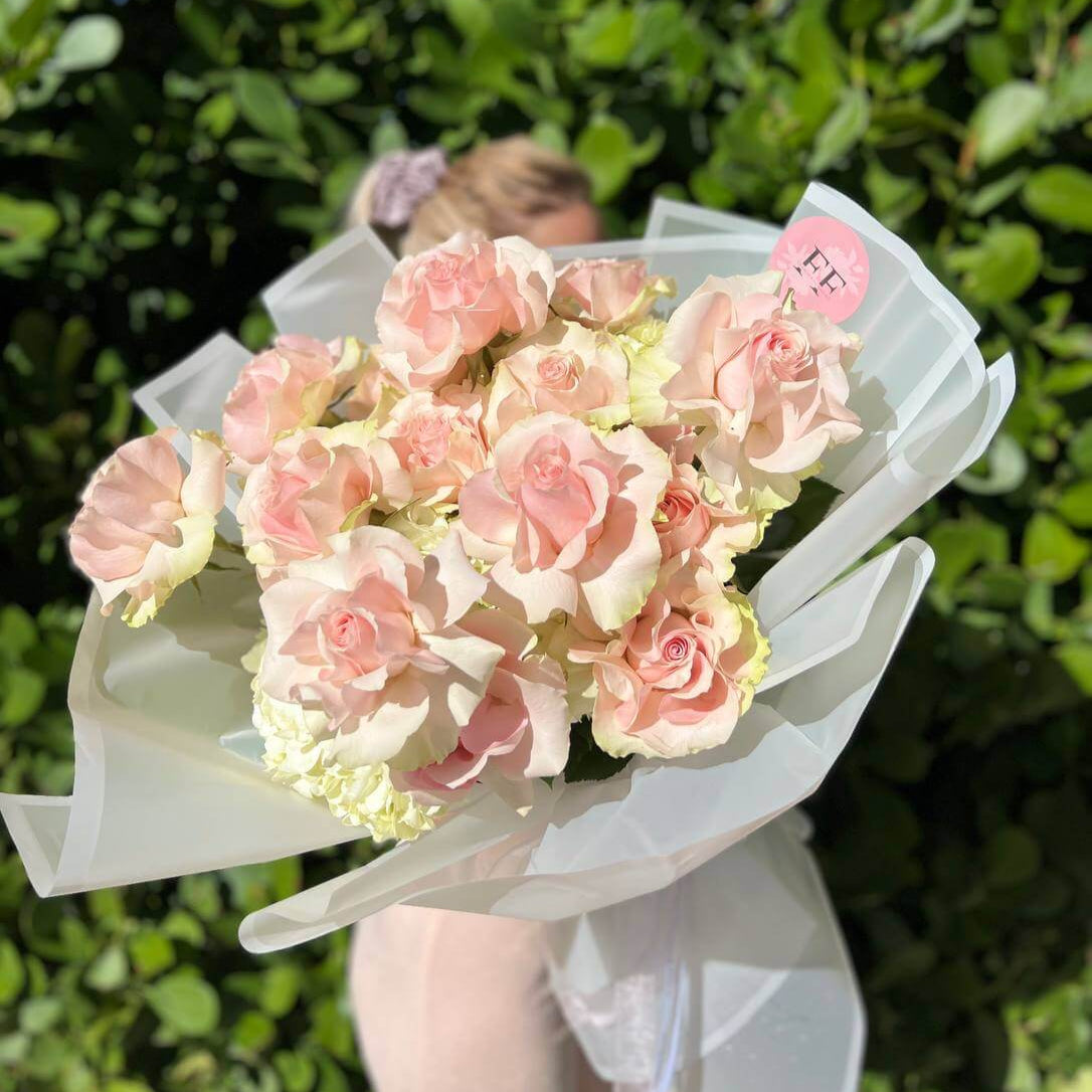 Pastel bouquet with pink roses and hydrangeas held by elegant woman â flower delivery Miami
