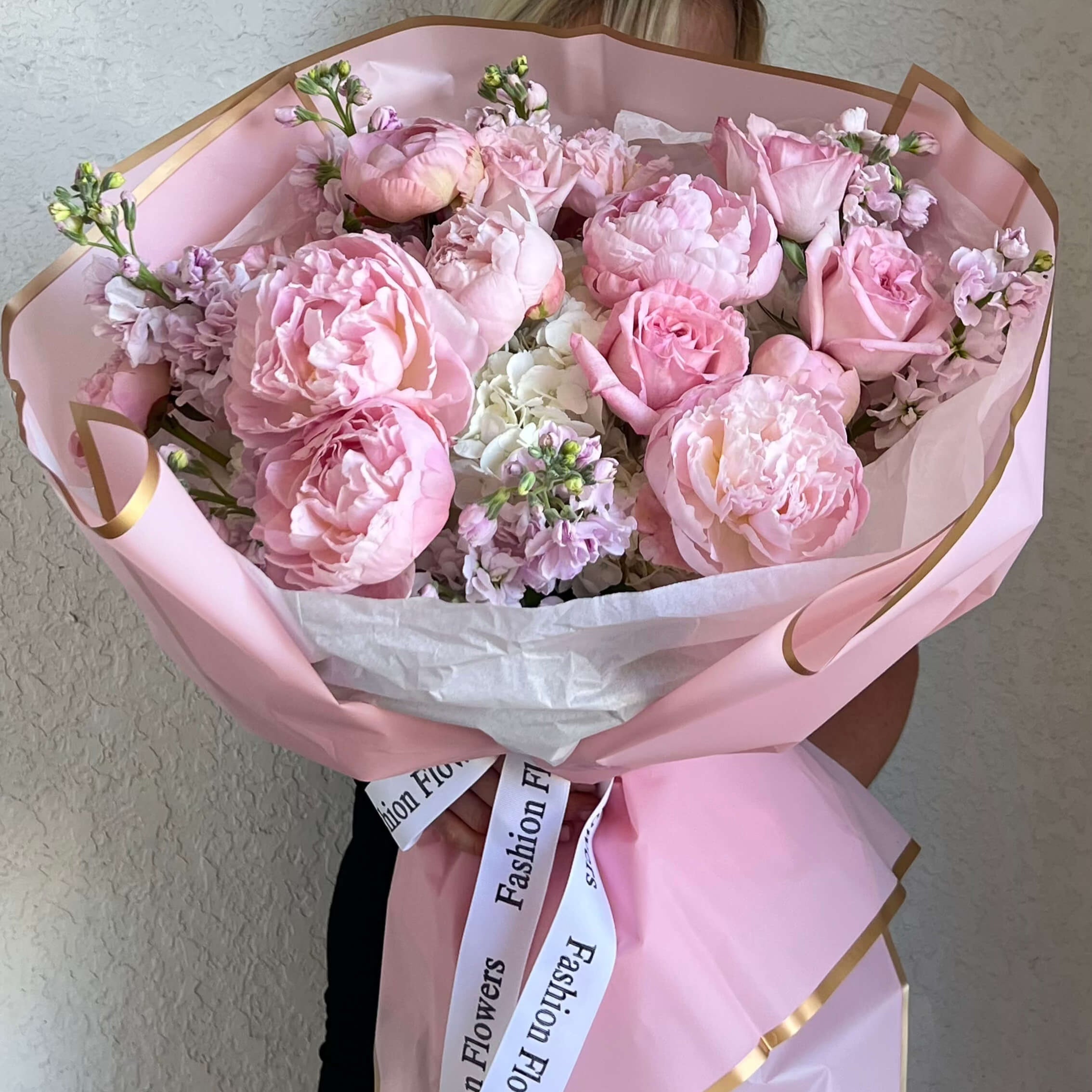 Flawless Pink bouquet with peonies and roses in soft pink wrap — luxury flower delivery Miami