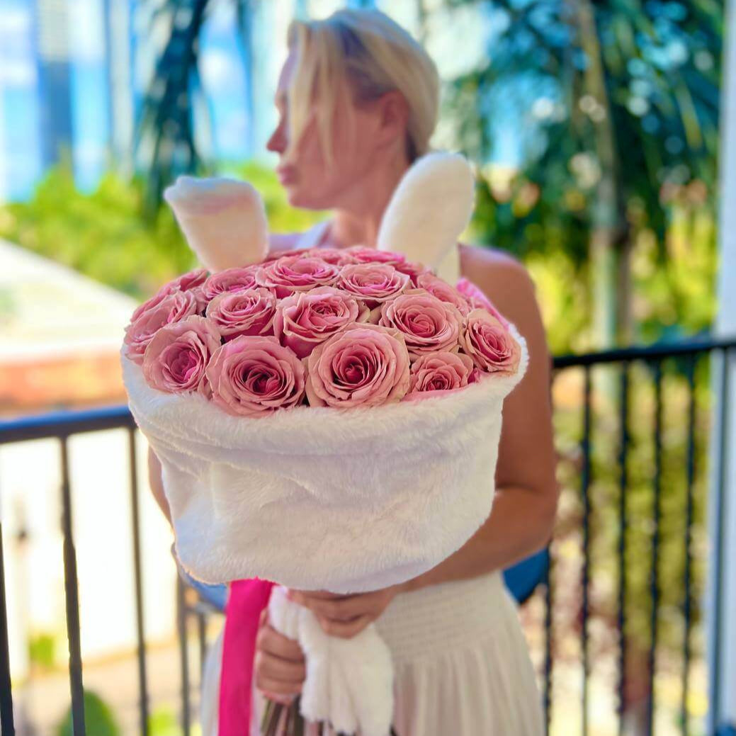 Funny Bunny hand-tied bouquet with soft pink roses in luxury lounge — same-day flower delivery Miami