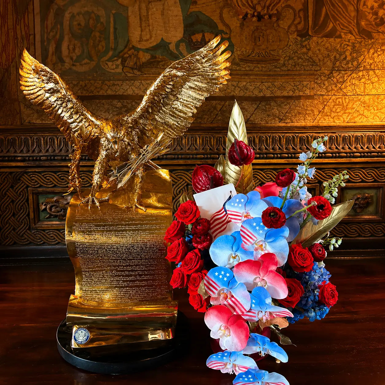 luxury patriotic flower arrangement with golden eagle sculpture red roses and blue orchids