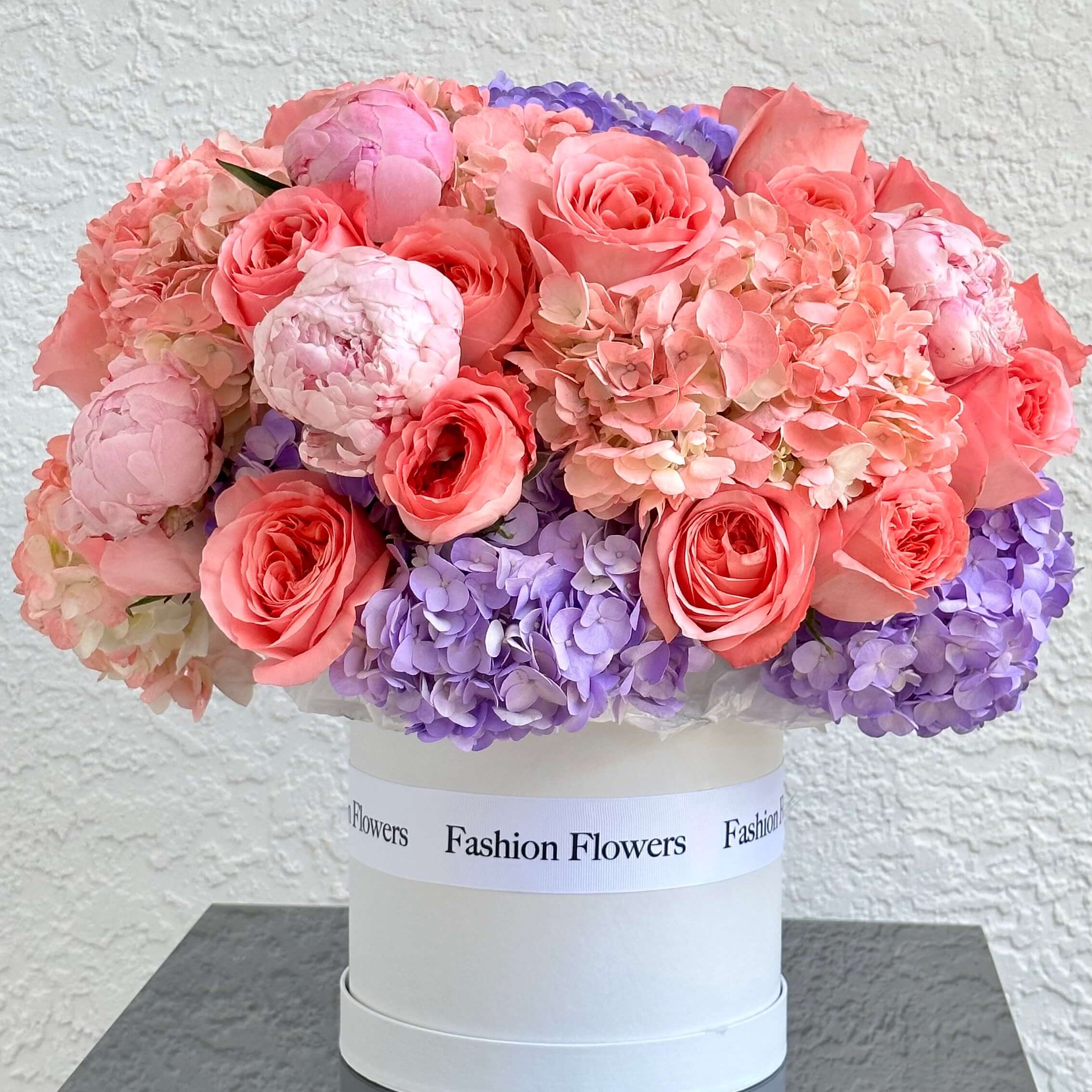 Colorful floral arrangement with roses and hydrangeas in a white box — Miami flower delivery
