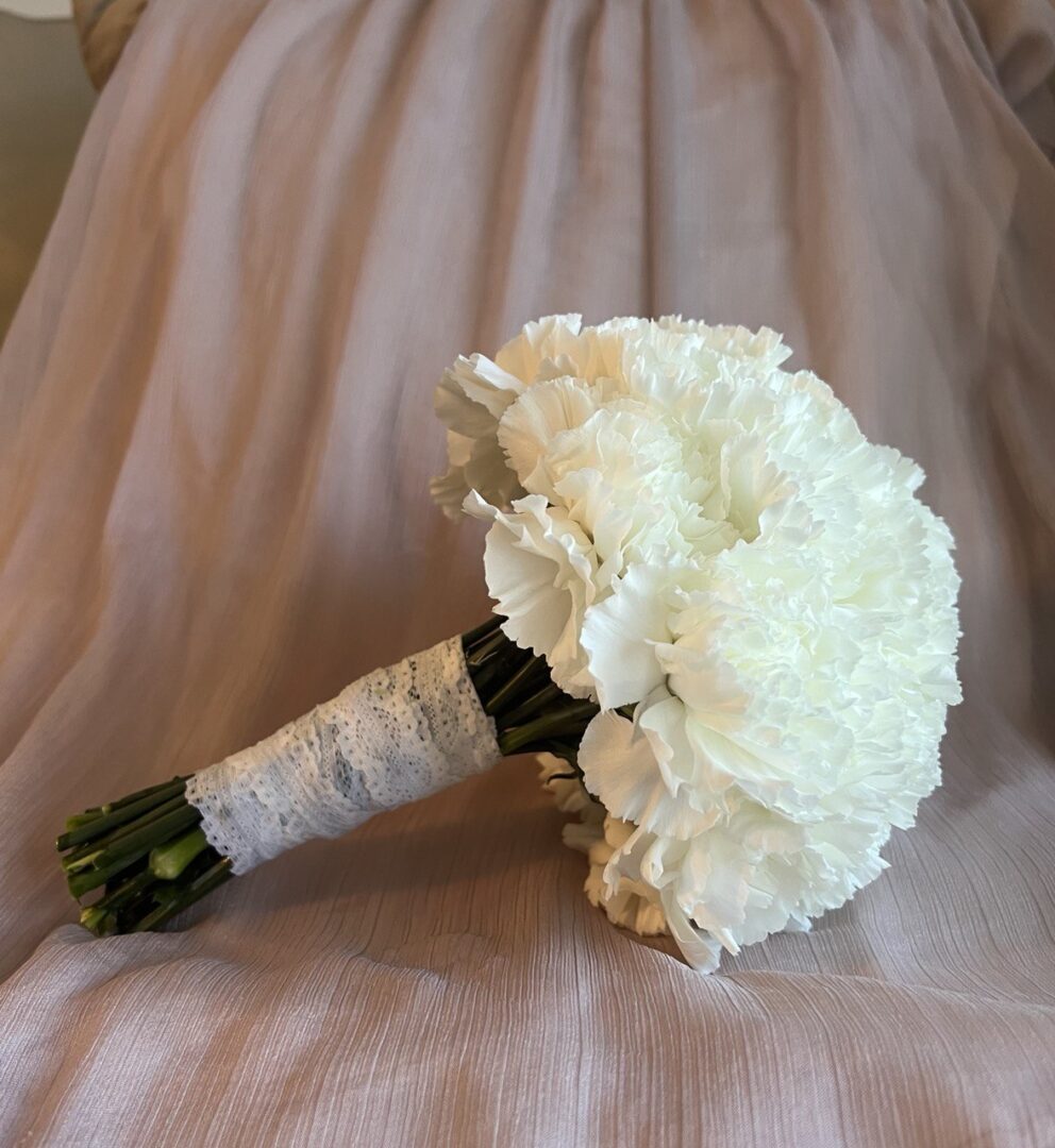 Just Carnation white bridal bouquet clearly visible under â flower delivery Miami