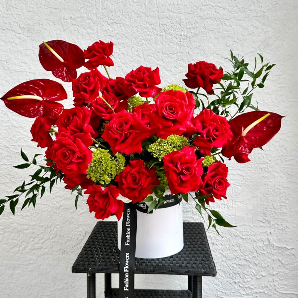 Kiss Me luxury bouquet with red roses and anthuriums in white box — elegant interior flower delivery Miami