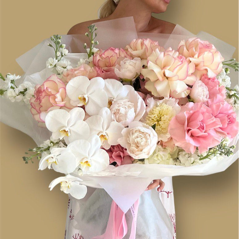 Luxurious hand-tied bouquet “Blooms Medley” with orchids and roses — elegant flower delivery in Miami