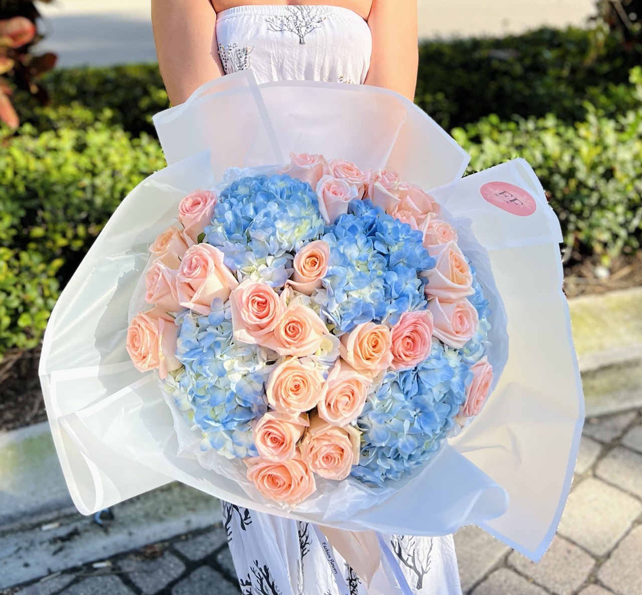 Marshmallow bouquet with dozens of small peach roses and blue hydrangeas — luxury floral delivery Miami