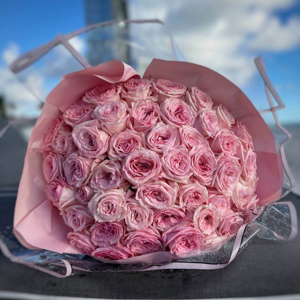 Luxury hand-tied bouquet of 150 soft pink garden roses with transparent wrap â flower delivery Miami