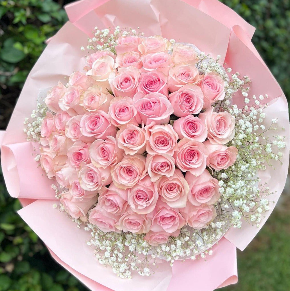 Elegant bouquet of 200 pink roses with transparent and pink wrapping — luxury same-day flower delivery