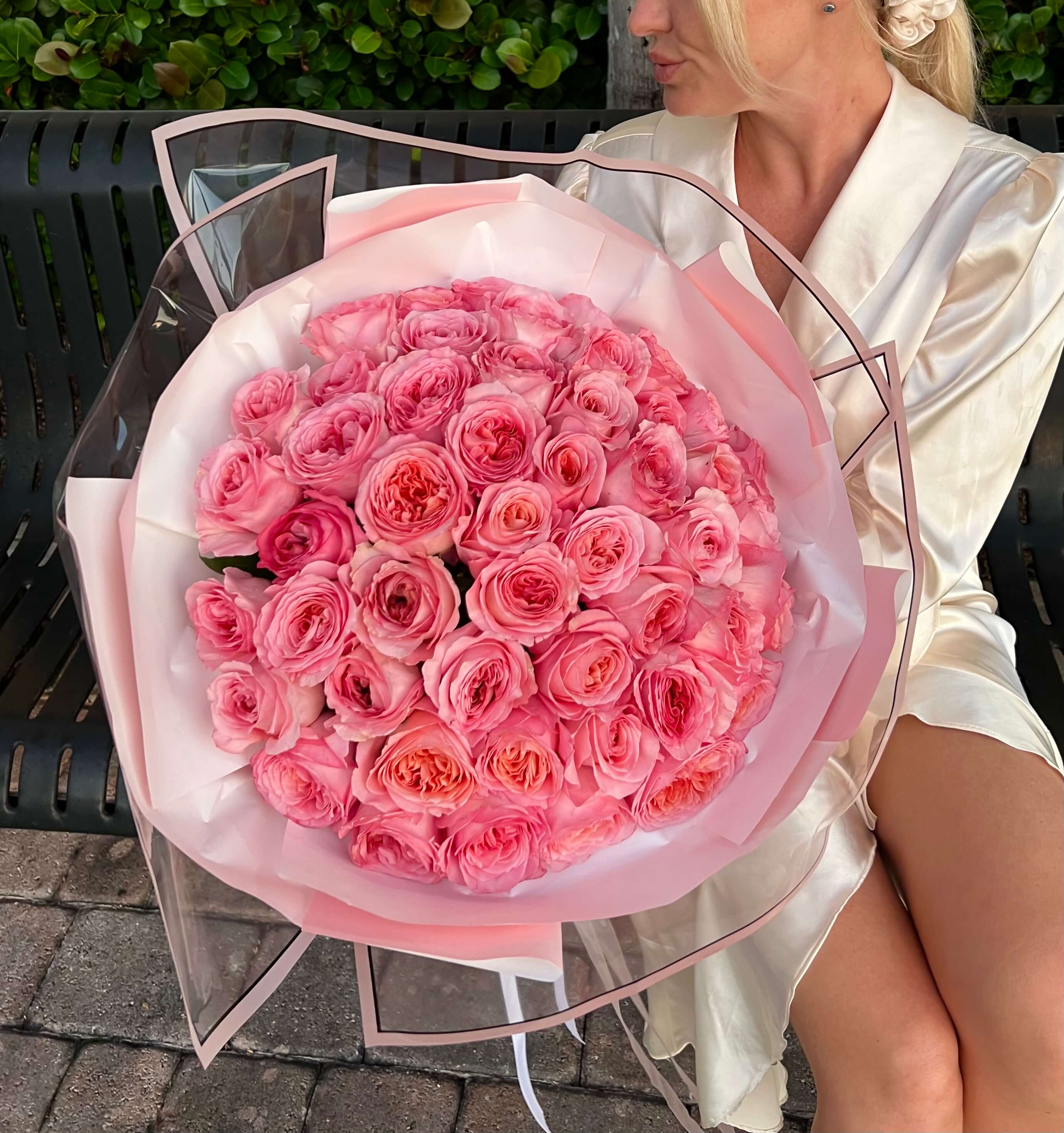 Limited luxury bouquet of 100 soft pink roses with pink and transparent wrapping â same-day flower delivery
