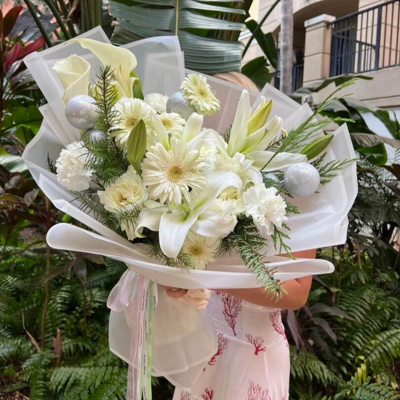 Snow White Tender bouquet with white roses, lilies and carnations in white wrap — luxury flower delivery Miami