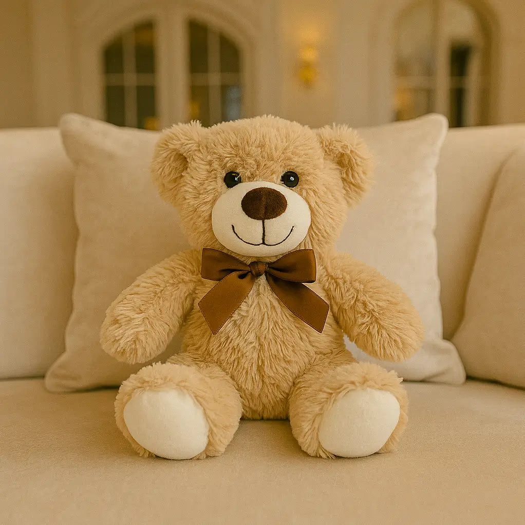 Soft teddy bear in creamy beige with brown bow sitting on a luxury sofa â romantic gift idea in Miami