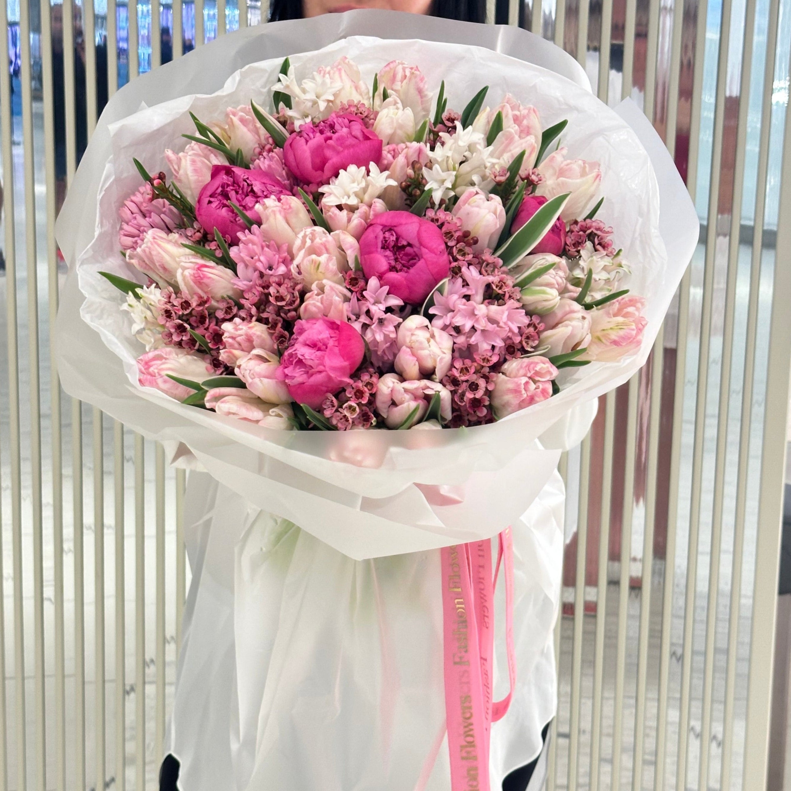 Spring Symphony bouquet with peonies, tulips and soft pink florals in white wrap â luxury flower delivery Miami