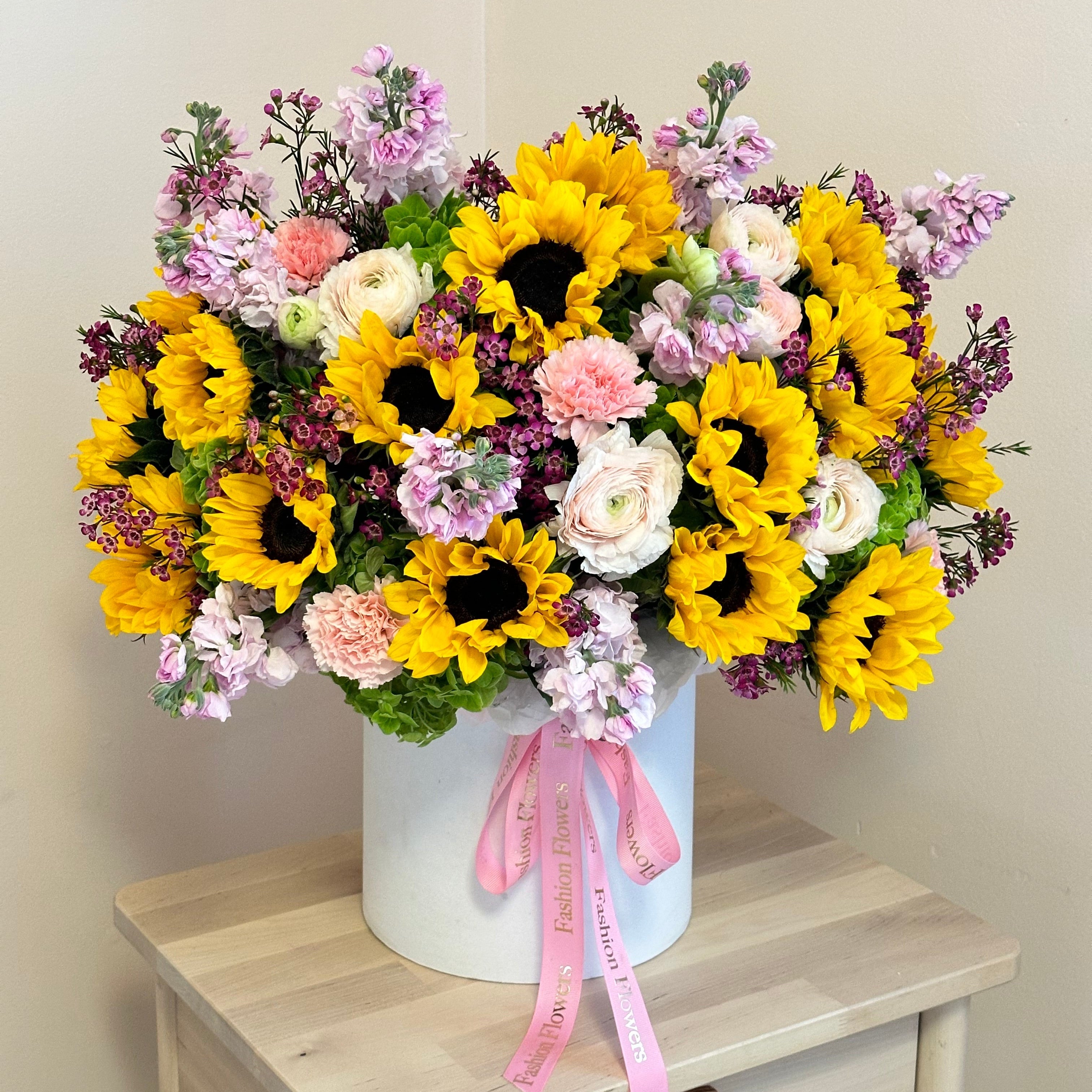 Sunflower Island bouquet with yellow, pink and white flowers in a white designer box — luxury gifting