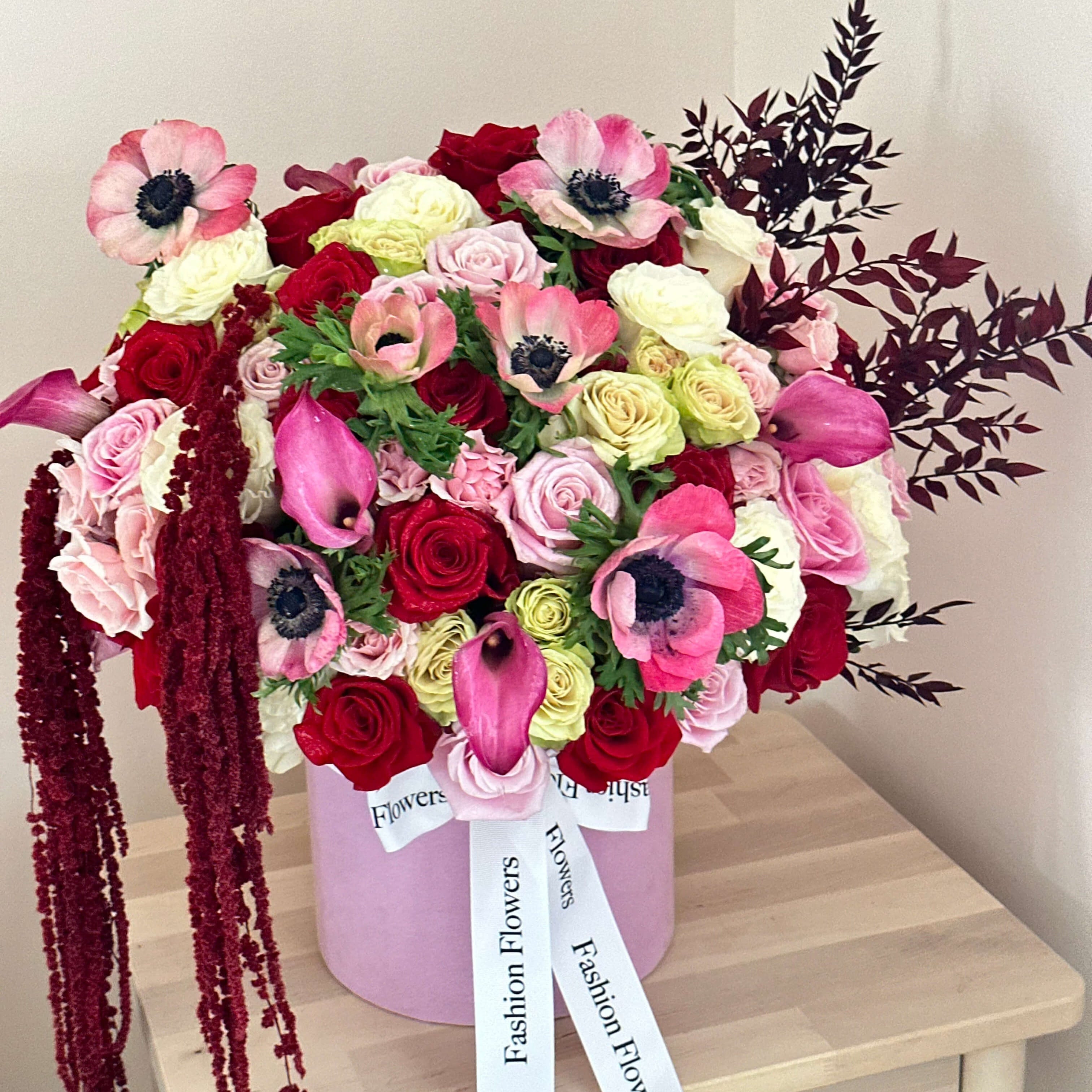 Vivian flower box with pink anemones, red and yellow roses â luxury bouquet on oceanfront terrace in Miami