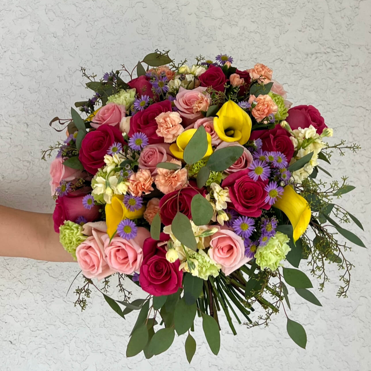 Elegant hand-tied bouquet with vivid roses and asters — Miami luxury flower delivery