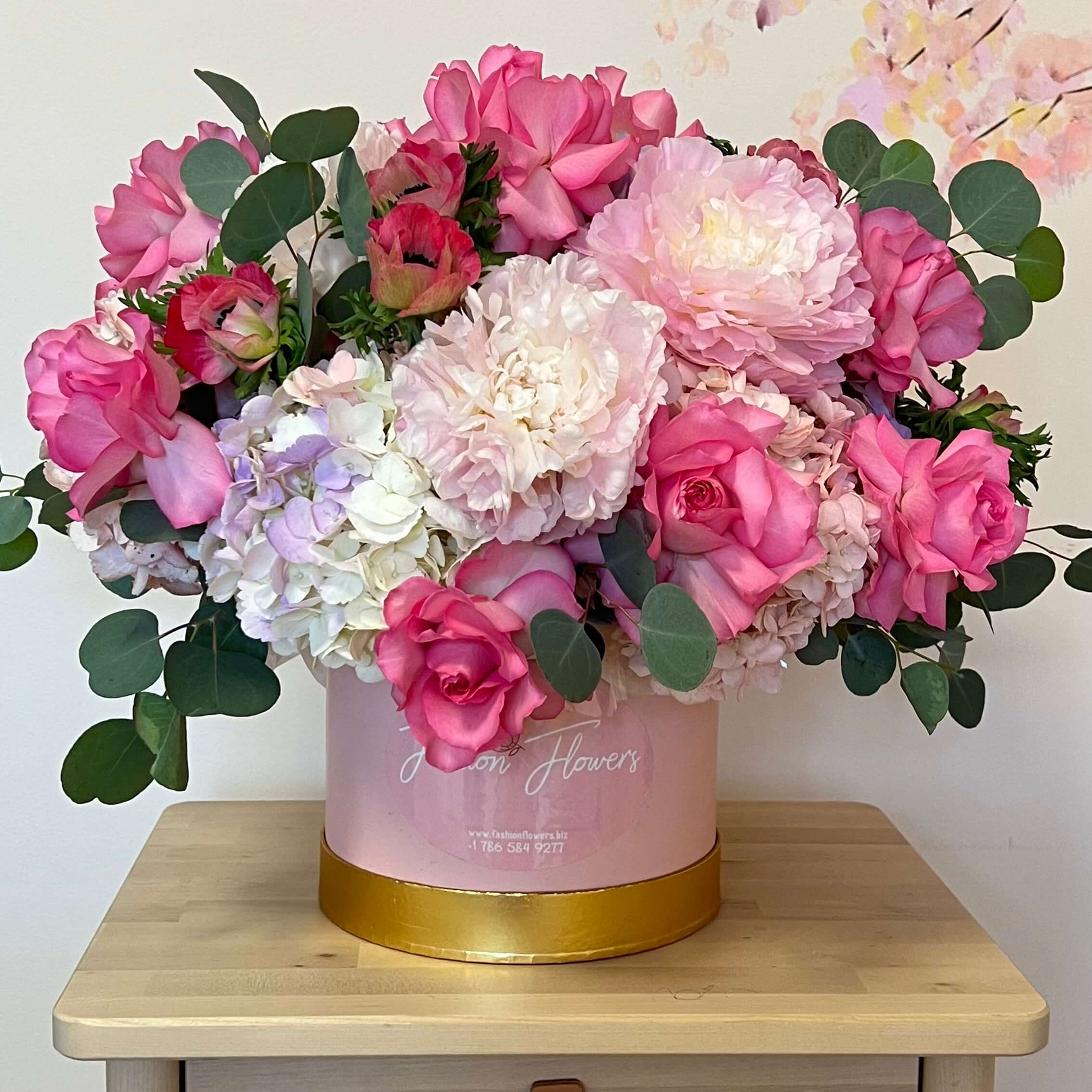 Pink and white peonies, roses, and hydrangeas in a designer hatbox — flower delivery Miami
