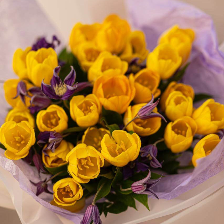 Extra-large yellow tulip bouquet with purple lisianthus in white and lavender wrap — luxury Miami flower delivery