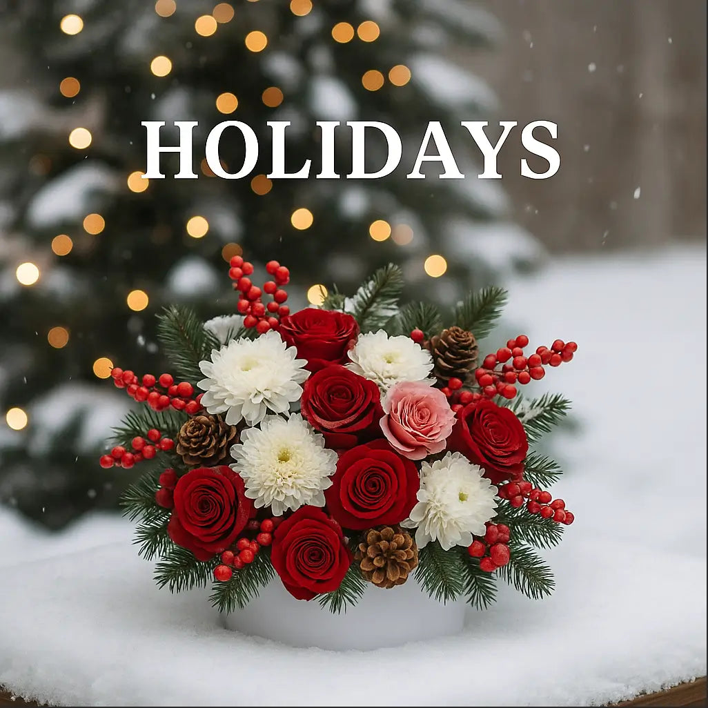 Festive bouquet with red roses, pinecones, and berries in snow — holiday floral arrangement