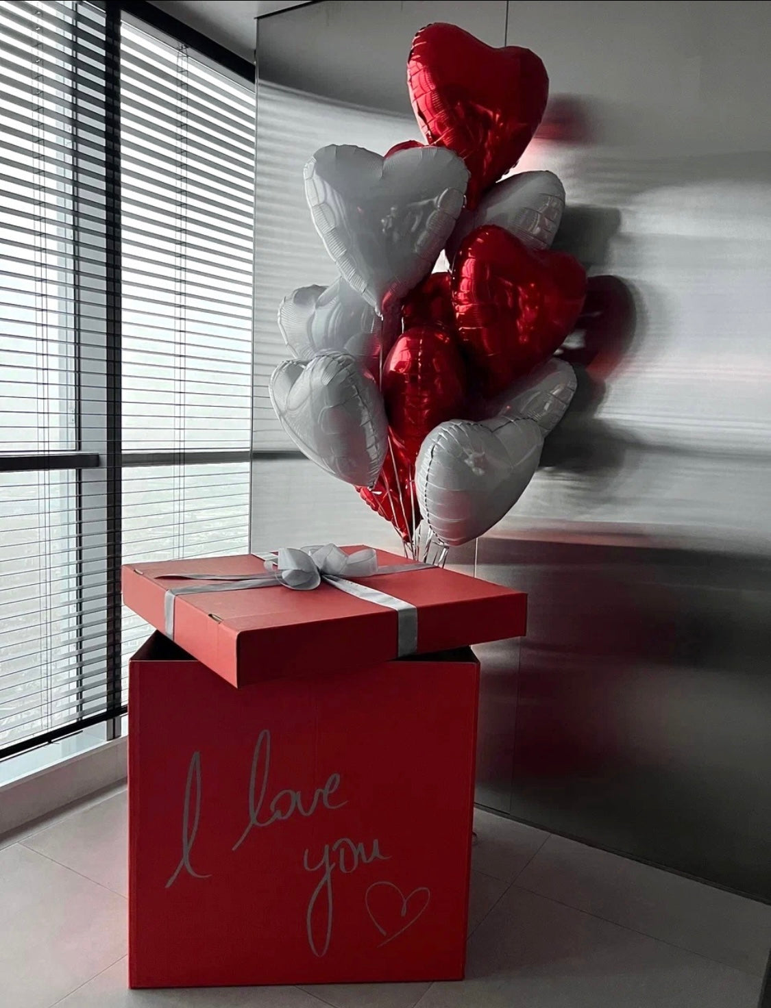 Valentine Surprise: red and white heart balloons, red gift box in a balloon surprise box