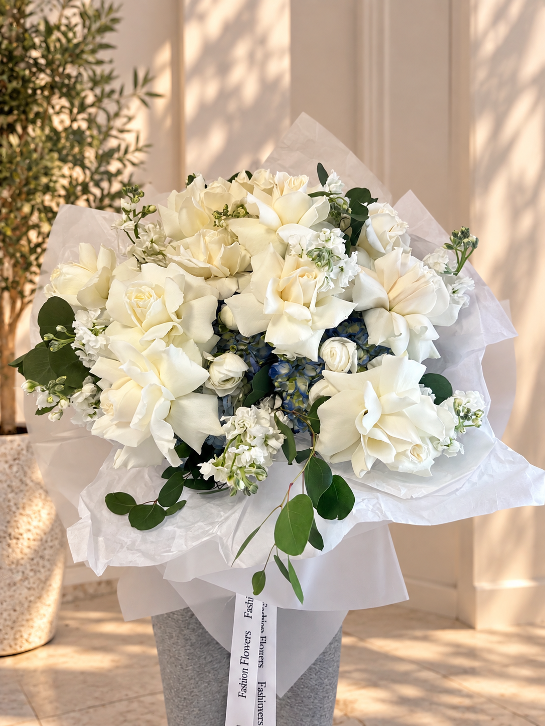 Hand-Tied Bouquet of white roses, blue hydrangeas, seasonal blooms, eucalyptus — Cloud Nine