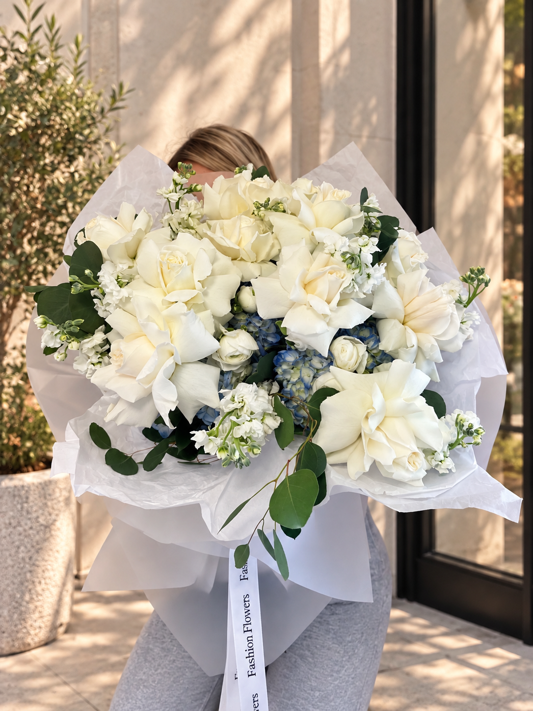 Cloud Nine: white roses, blue hydrangeas, seasonal blooms, eucalyptus in a hand-tied bouquet