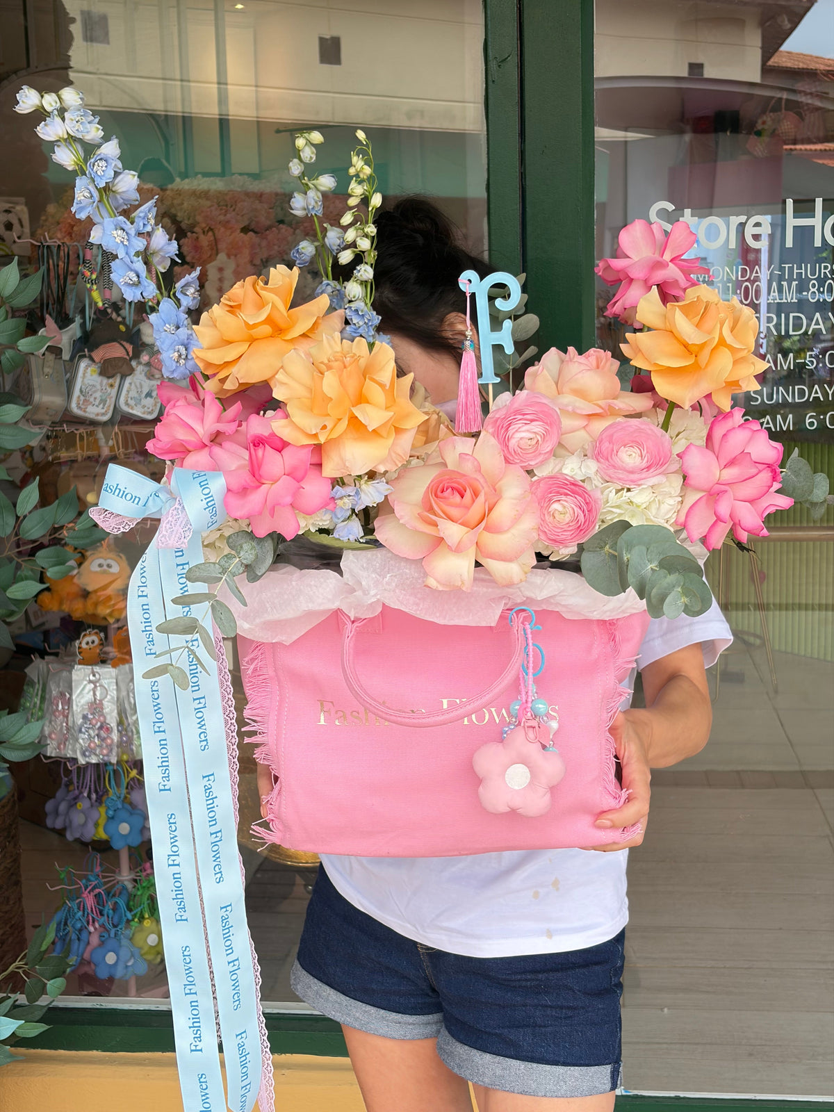 Fashion Muse flower bag arrangement featuring fresh seasonal flowers, decorative details, accessories