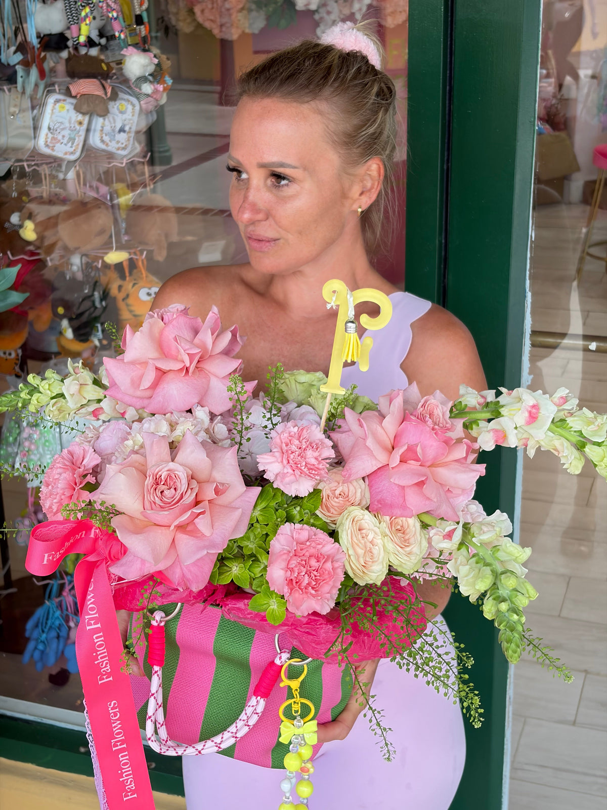 Glamour flower bag arrangement featuring fresh seasonal flowers, decorative charms, reusable bag