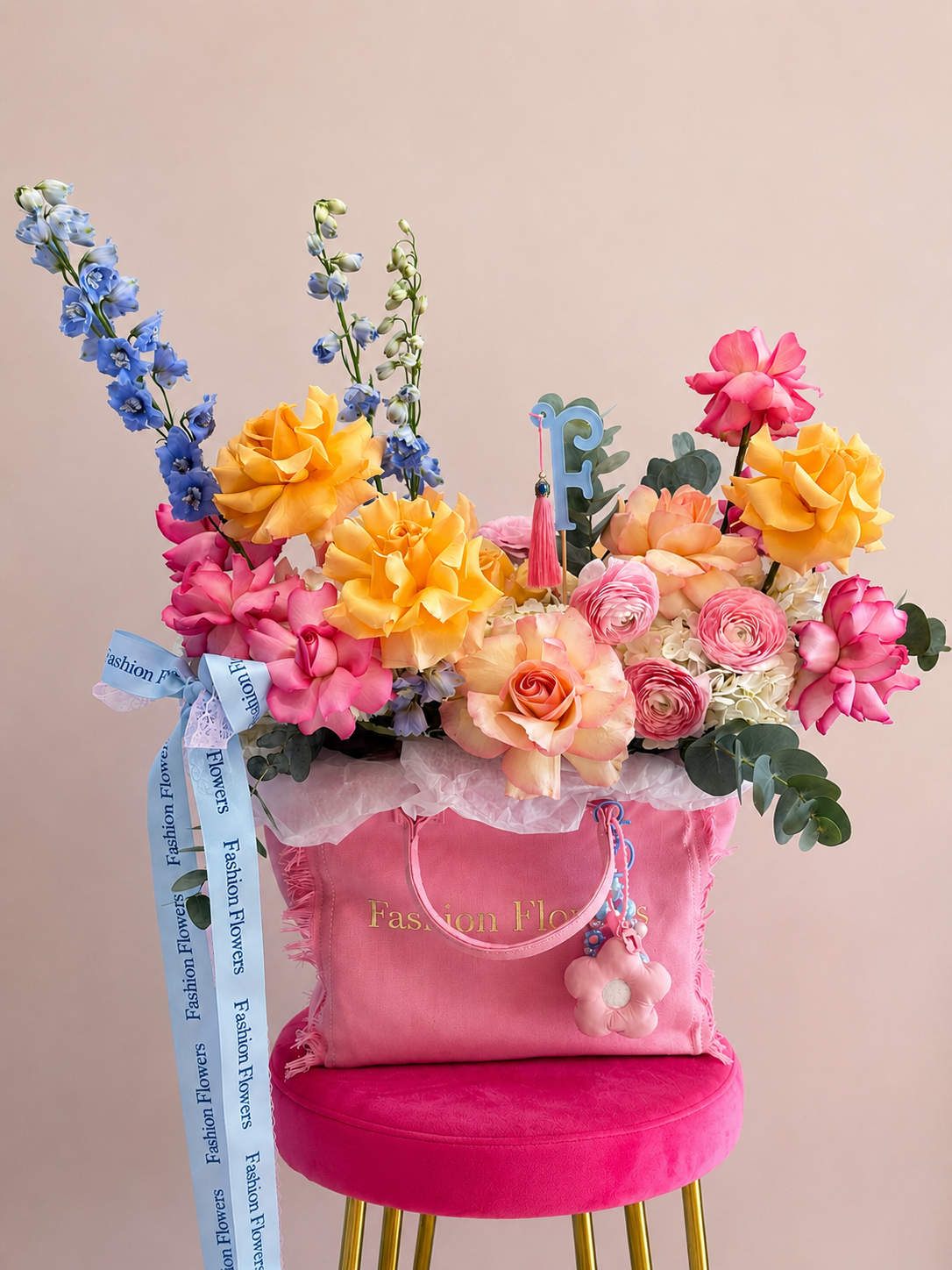 Fashion Muse: fresh seasonal flowers, decorative details, accessories in a flower bag arrangement
