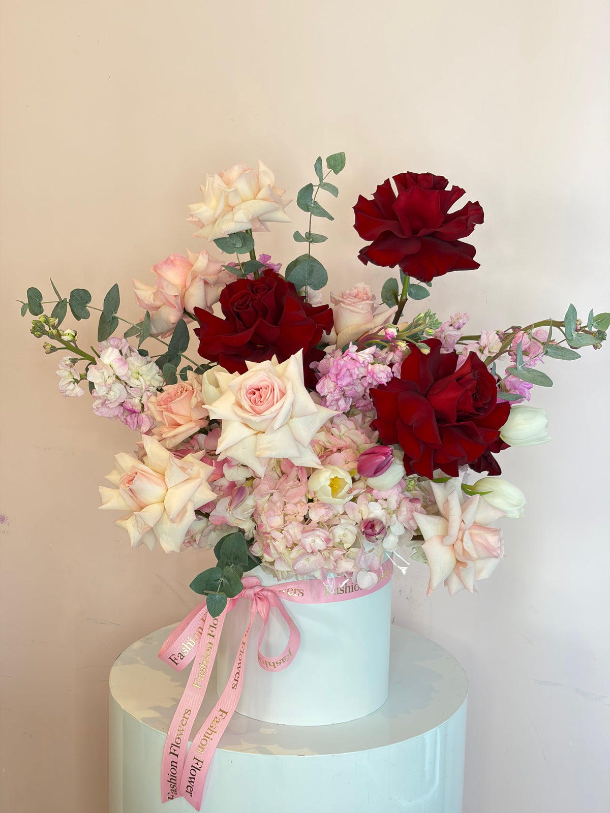 Crimson Kiss: roses, garden roses, hydrangeas, eucalyptus in a flower box arrangement