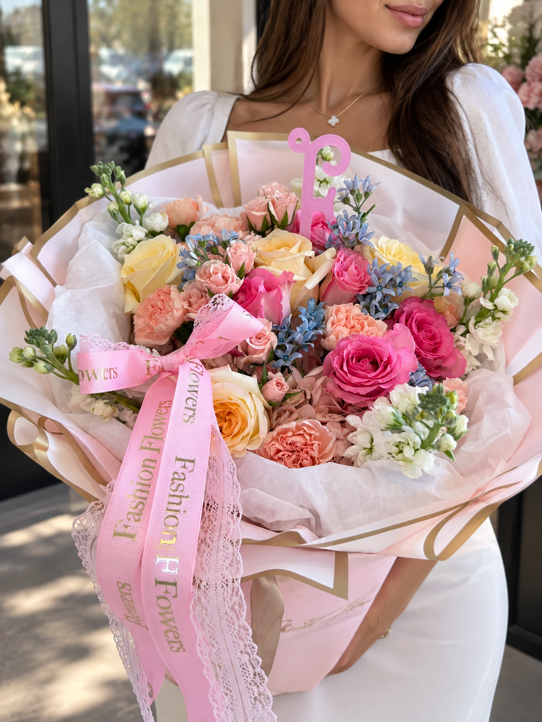 Pastel Love Story: roses, spray roses, carnations, seasonal blooms in a hand-tied bouquet