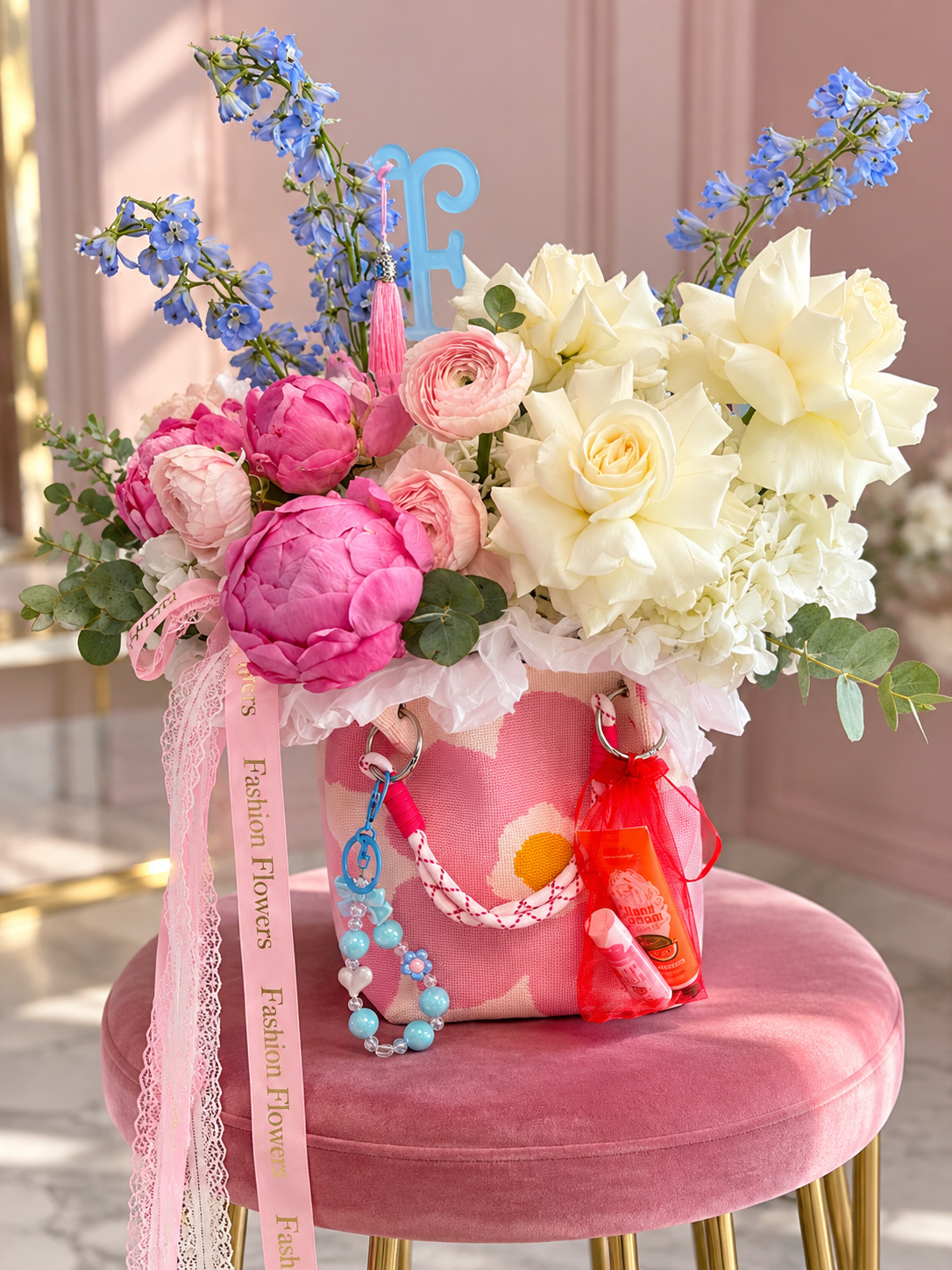 Pretty Little Things: white roses, hydrangeas, pink blooms, eucalyptus, blue accents in a flower bag arrangement
