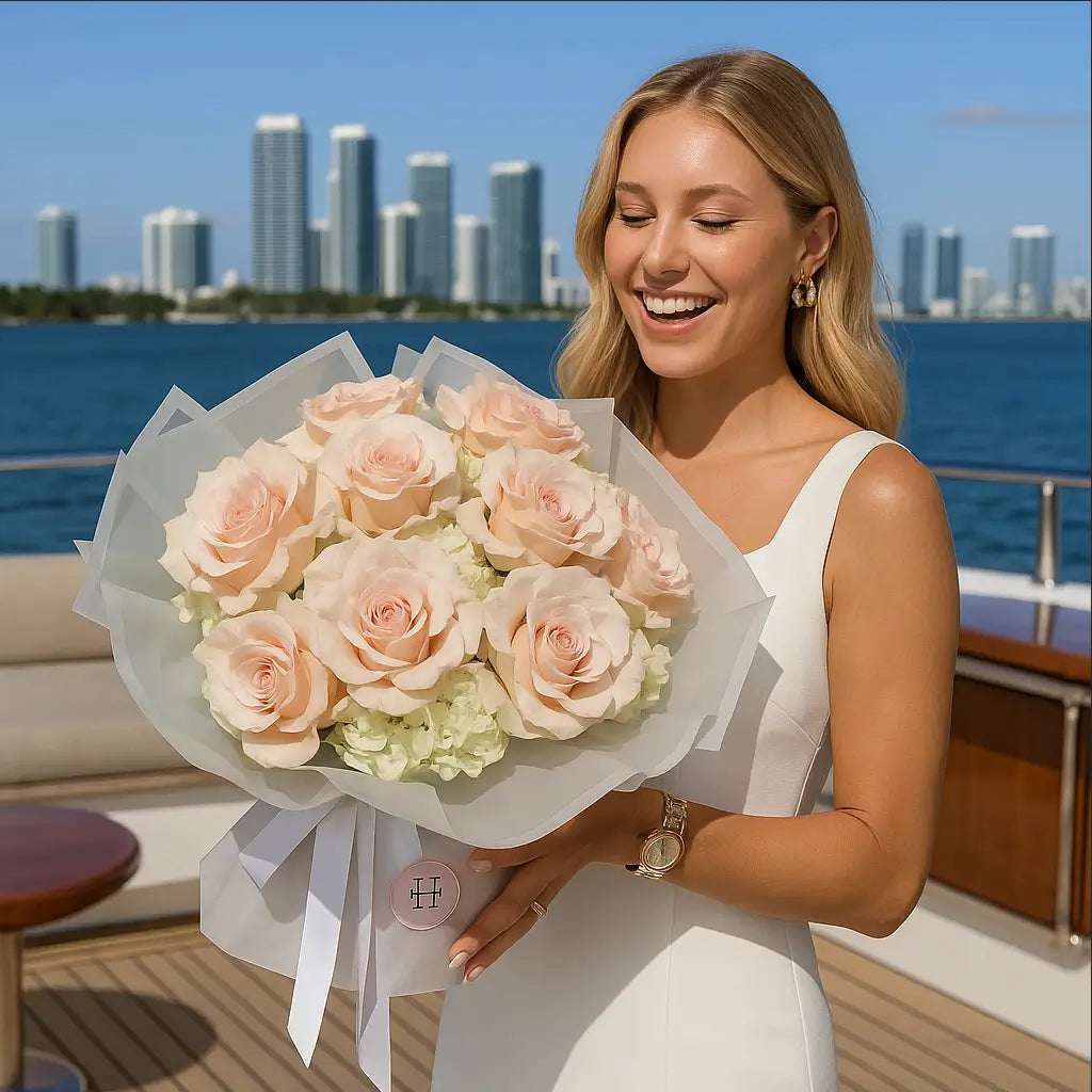 Large pastel hand-tied bouquet with soft pink roses and hydrangeas on a yacht — luxury flower delivery Miami