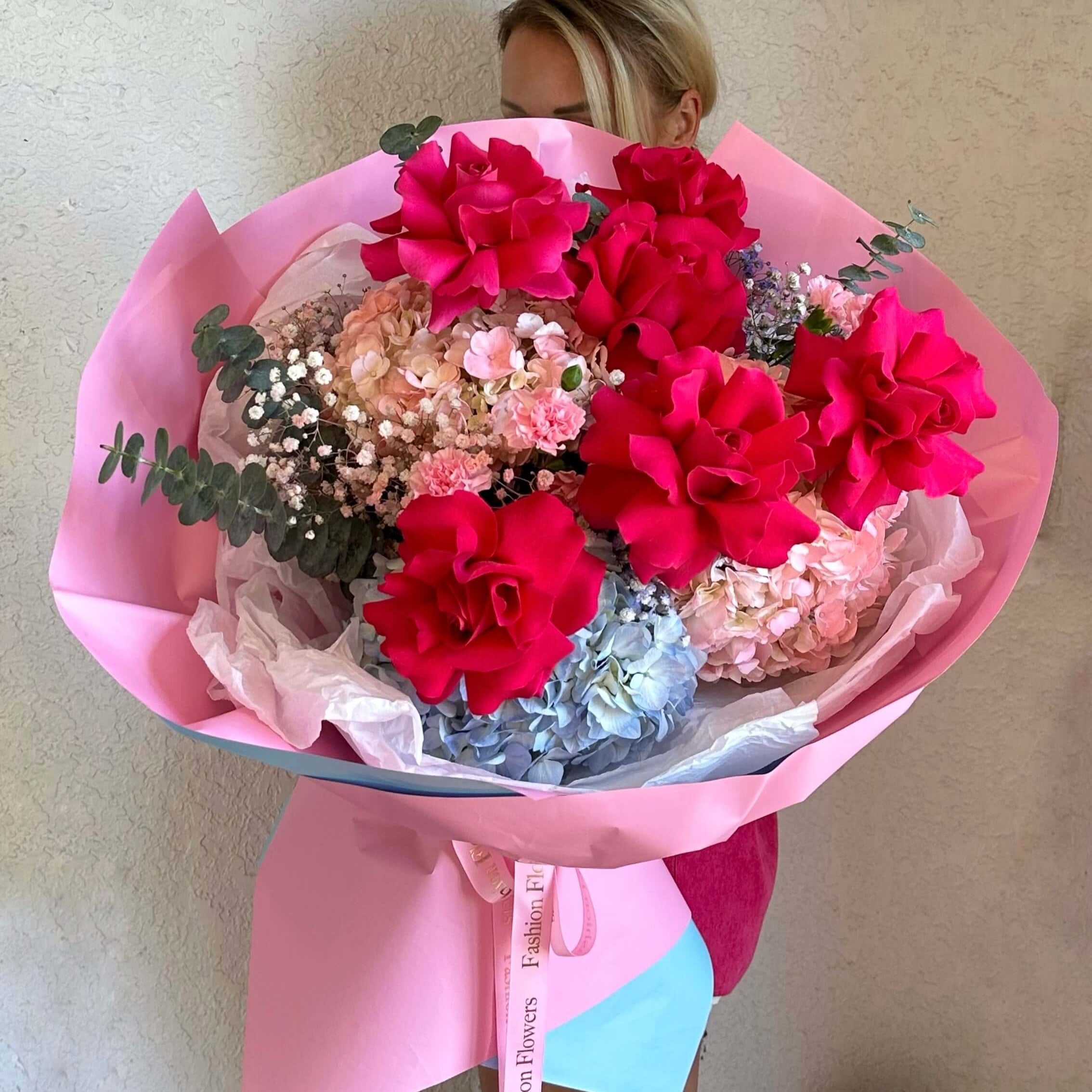 Elegant hand-tied bouquet with red roses and pastel hydrangeas— romantic flower delivery Miami