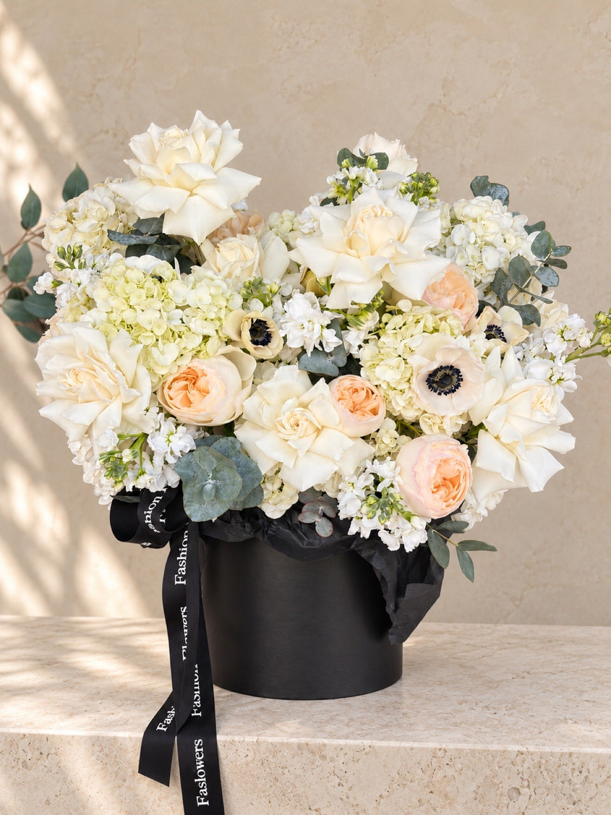 Ivory Serenade: roses, hydrangeas, anemones, garden roses, eucalyptus in a flower box arrangement