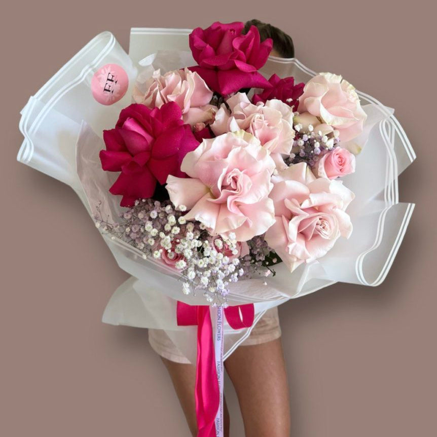 Pink Blush bouquet with blush and magenta roses wrapped in white with satin ribbon — luxury flower delivery Miami