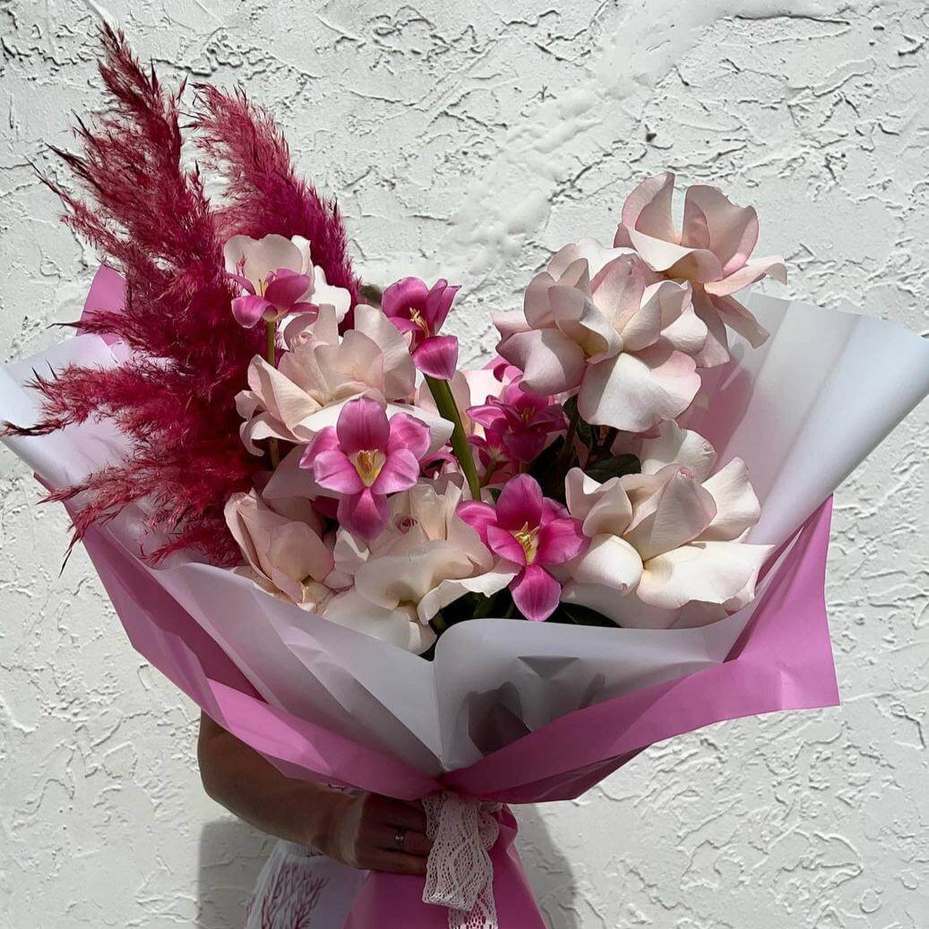 Pink Breeze hand-tied bouquet with orchids, blush roses and pampas in pink and white wrap — luxury Miami delivery