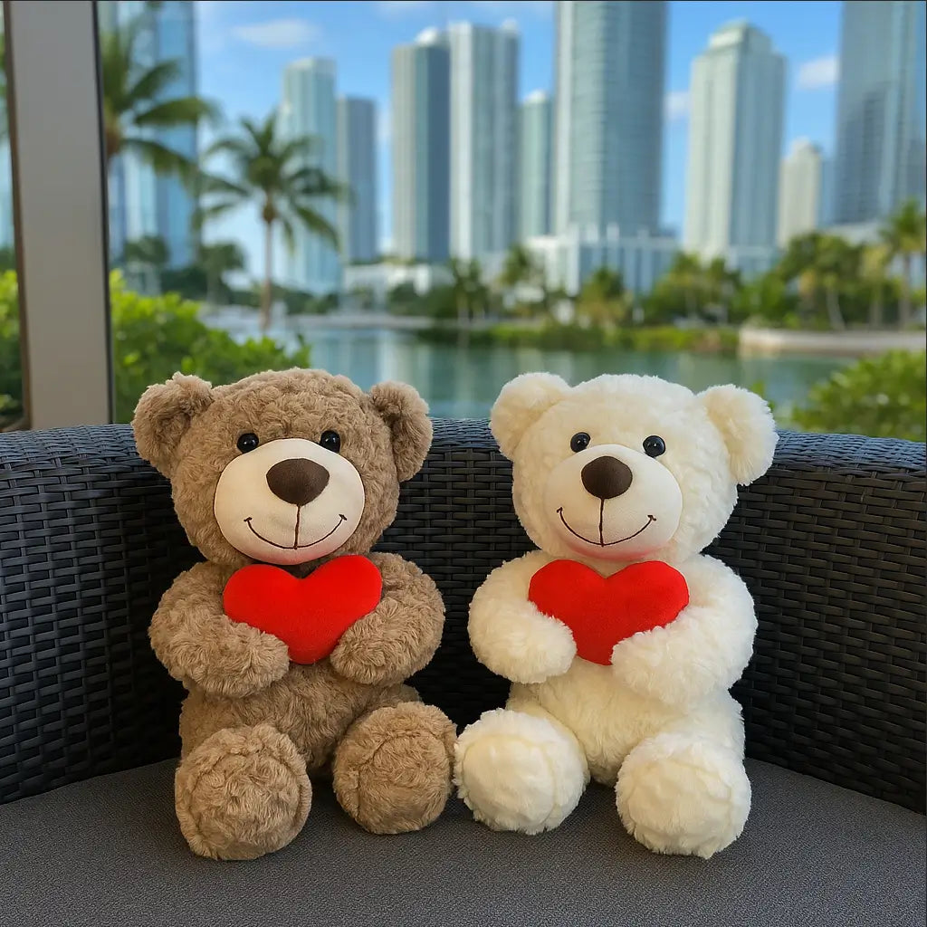 Brown and white teddy bears holding red hearts seated on a luxury sofa with Miami skyline view — perfect romantic gift