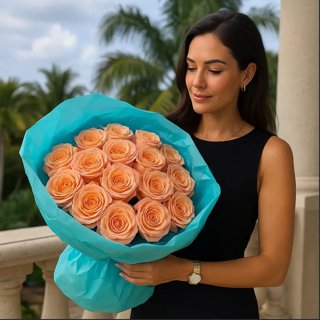 Hand-tied bouquet of peach roses in turquoise wrapping held by a woman on a luxury balcony — artistic flower delivery in Miami