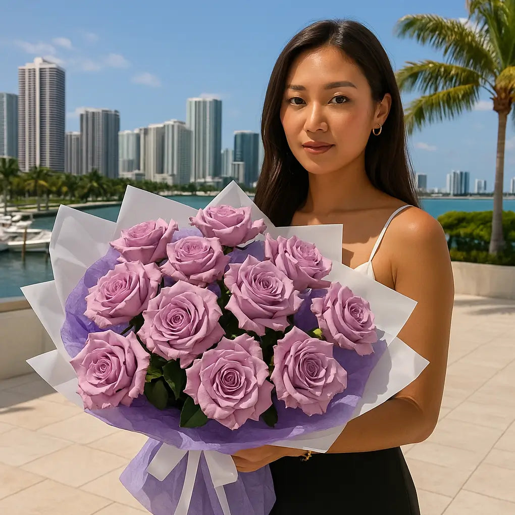 Hand-tied bouquet of lavender roses in purple wrapping held by woman near Miami marina and skyline — unforgettable luxury flower gift